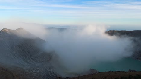 ijen volcano crater releasing toxic sulfur gases at dawn in east java, indonesia. - aerial shot