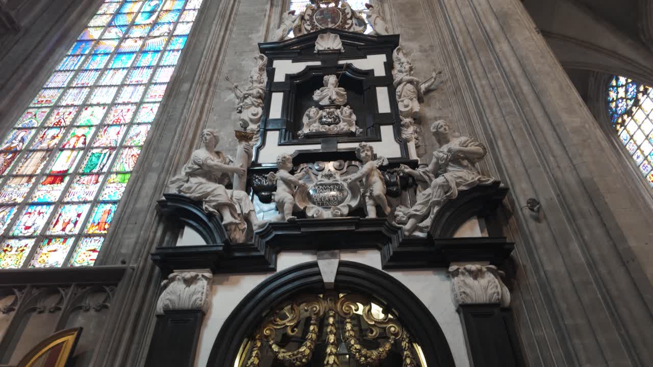 A beautiful baroque interior with ornate sculptures, stained glass, and religious art