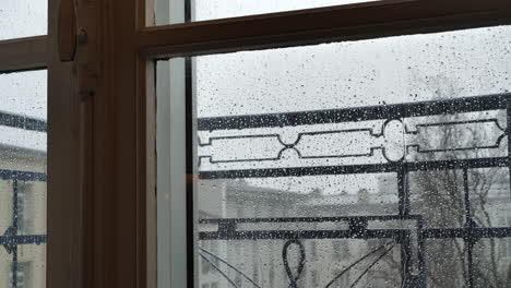 Rain-Drops-Hitting-Apartment-Window-On-Gloomy,-Grey-Day