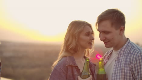 girl whispers her boyfriend in the ear words of love. they smile and enjoy moments with each other on the roof.