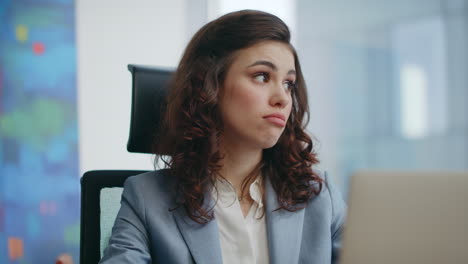 lady manager consulting online looking laptop camera at workplace close up.