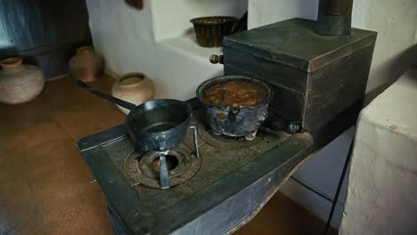 vintage wood burning stove with pots, showcasing traditional cooking in kumrovec, croatia