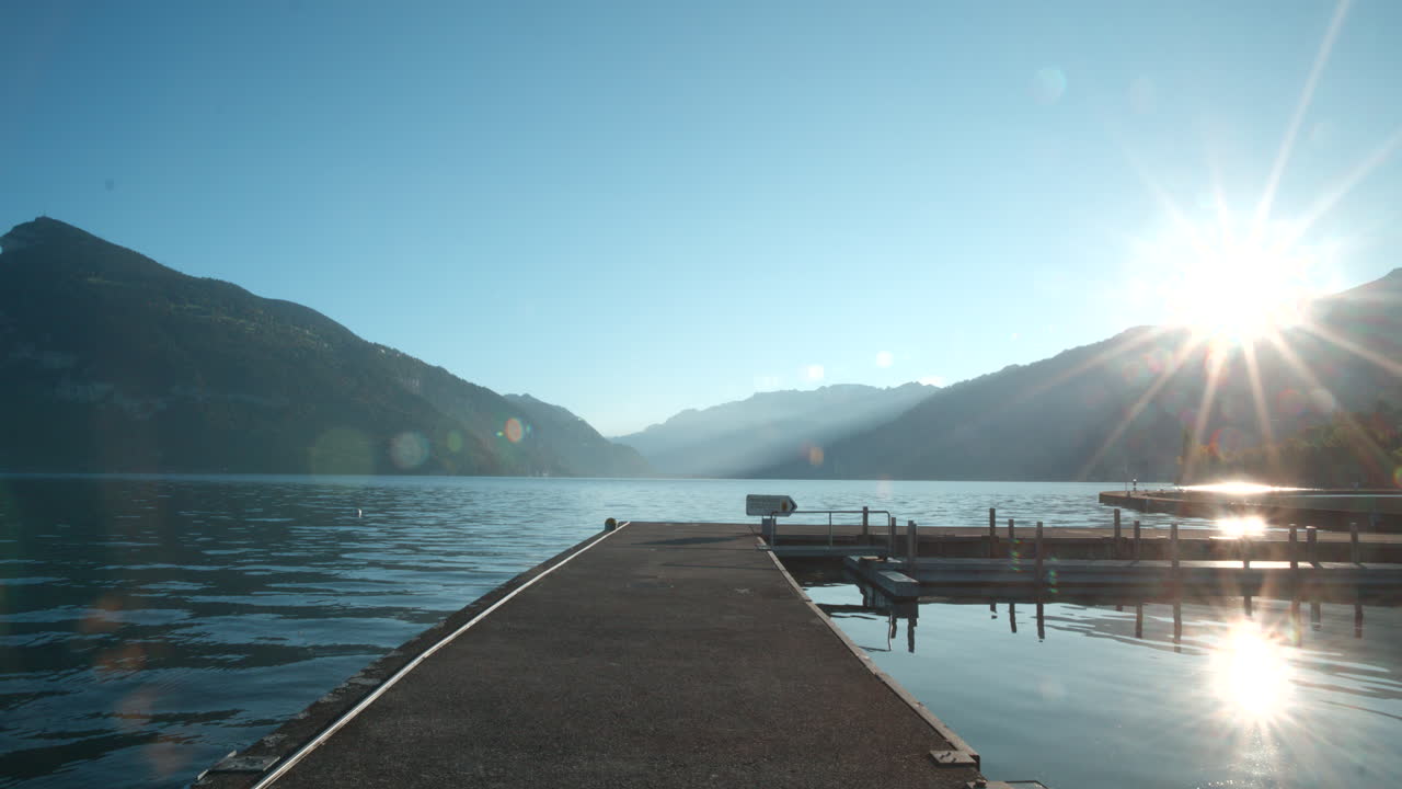 Sunrise over a Calm Lake with Mountains in the Background