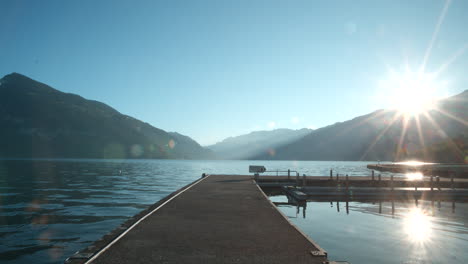 sunrise over a calm lake with mountains in the background