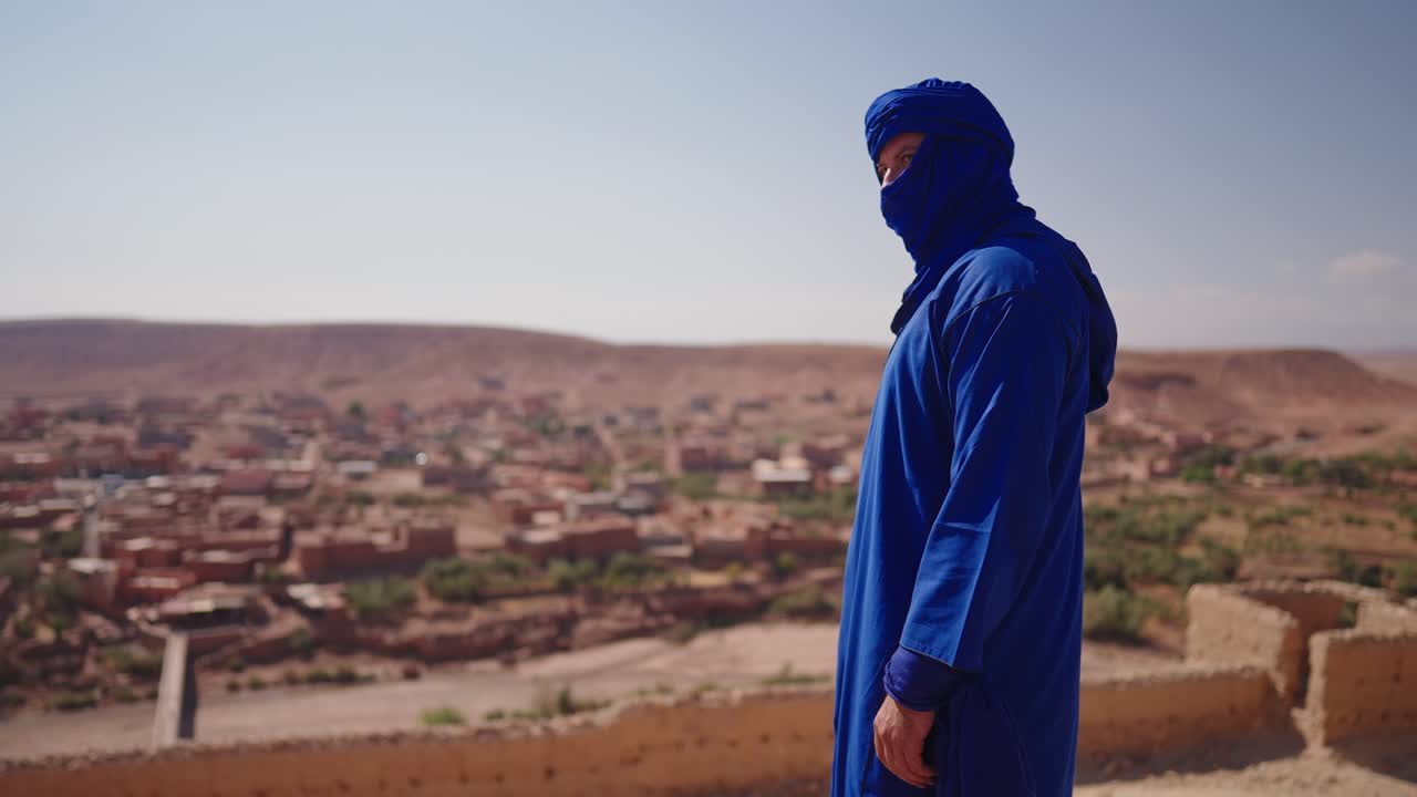 Man in traditional Moroccan clothing in the desert