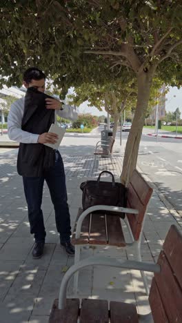 businessman arriving at park bench area with briefcase