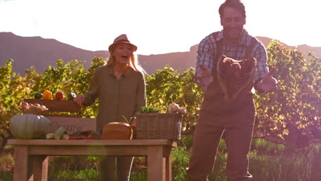 smiling farmer letting chicken fly in slow motion