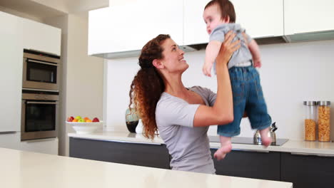 happy mother playing with baby boy