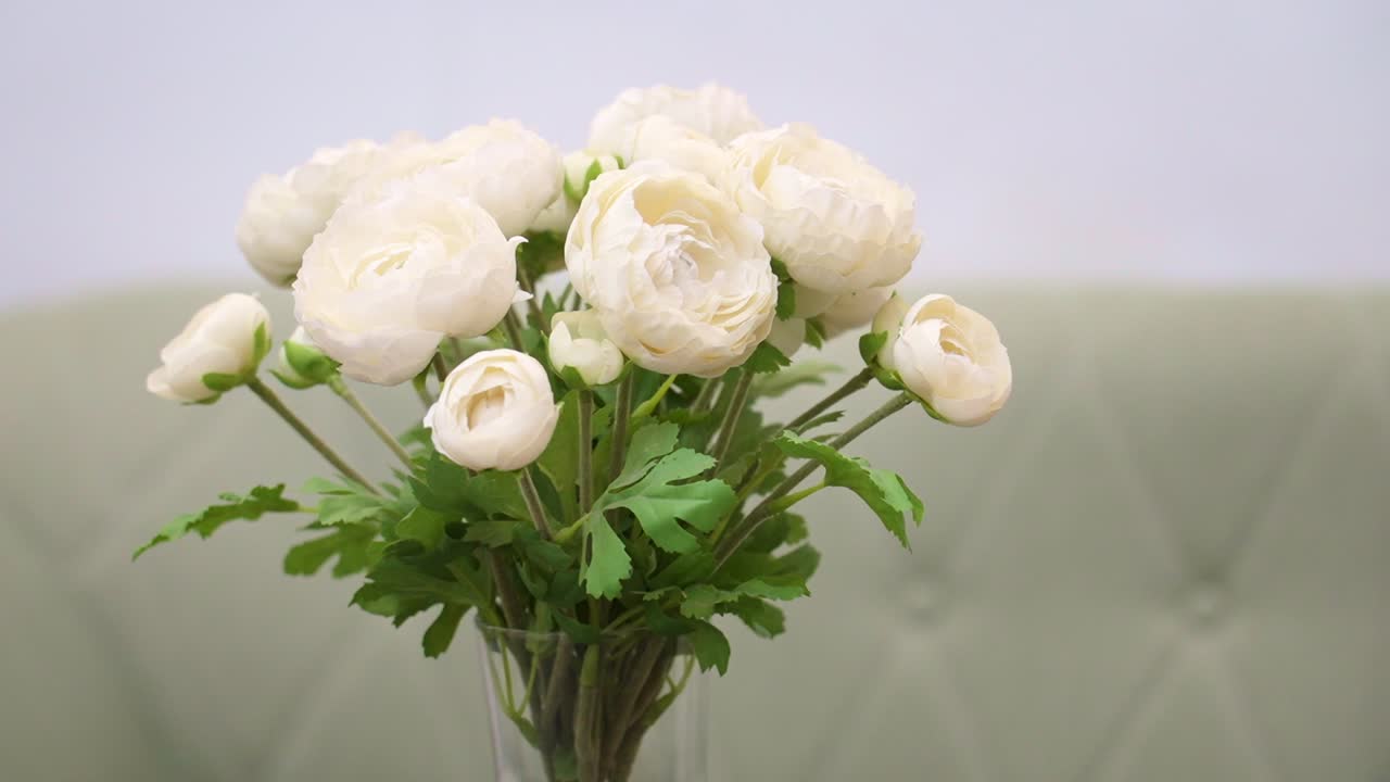 Close-up of white flowers in a vase in a hotel lobby