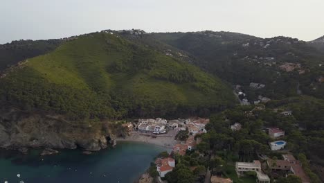 Aerial-view-of-Cala-Sa-Tuna,-a-beautiful-small-town-in-the-Costa-Brava-of-Catalonia