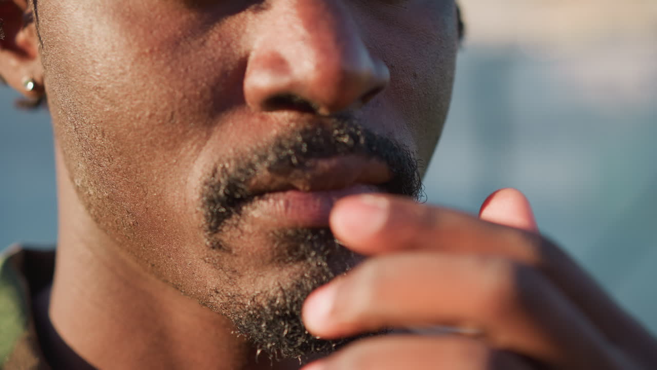 Close Shot Of Contemplative Man On Street, Portrait Of Serious Man Touching Lips Under Golden Illumination, Detailed Closeup Of Pensive Male Figure With Textured Facial Hair And Earring