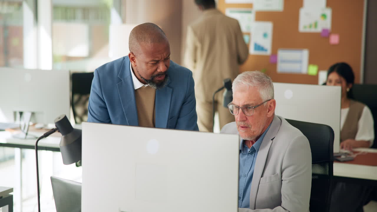 Two Businessmen Collaborating on Computer in Modern Office