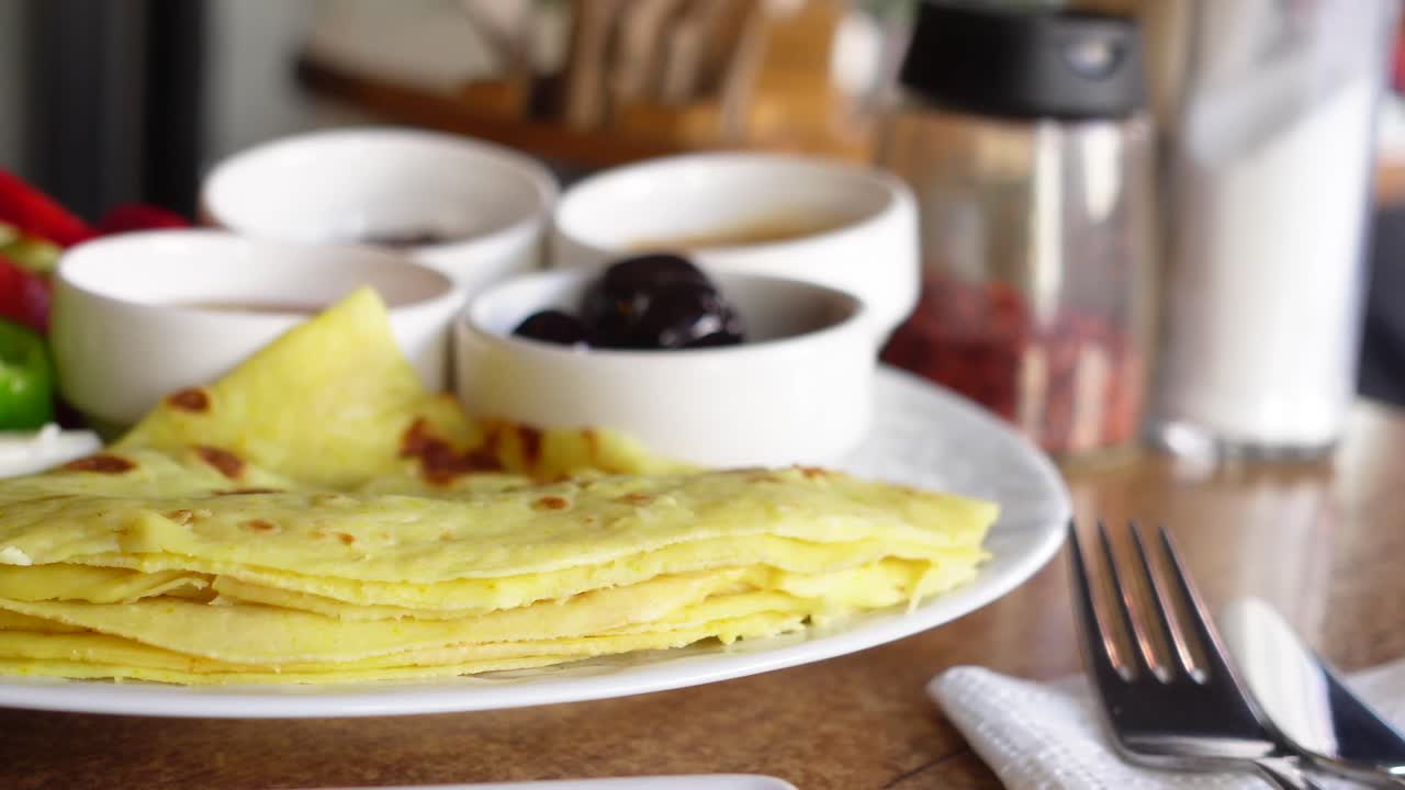 Breakfast with Pancakes, Olives, Cheese, Peppers, and Honey