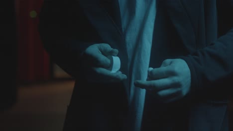 person putting tape on a jacket at night