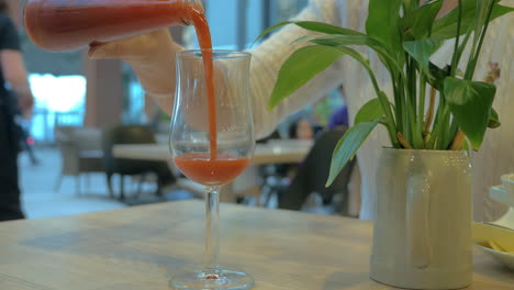 Woman-having-a-drink-in-cafe