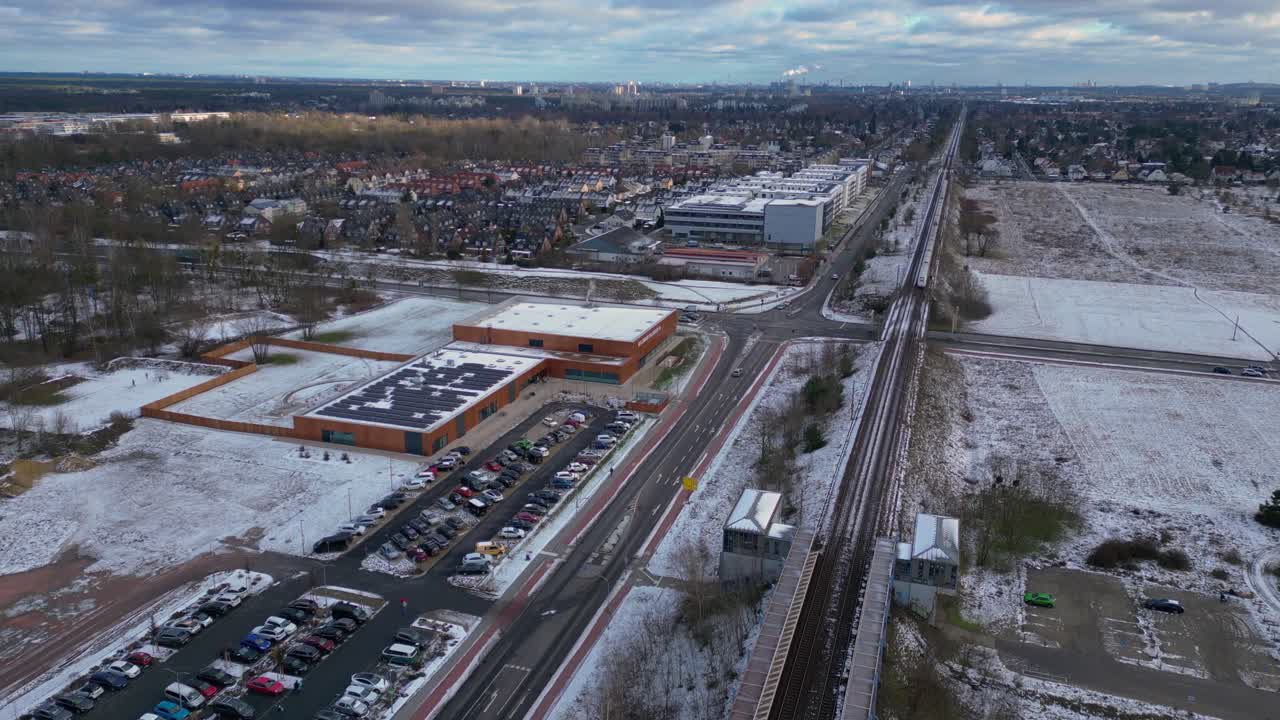 train traveling through a snowy cityscape in segefeld Falkensee. Fabulous aerial view flight panorama overview drone