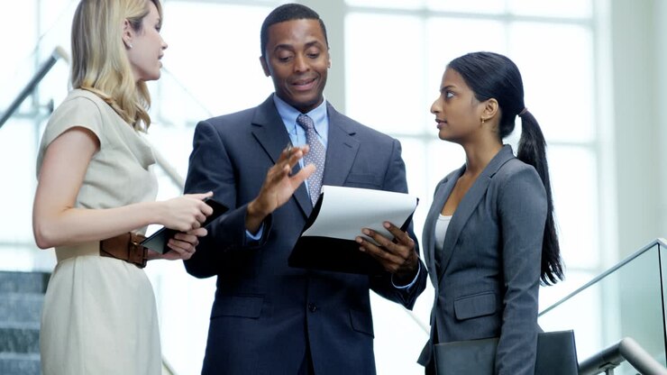 Young multi ethnic business people using wireless technology