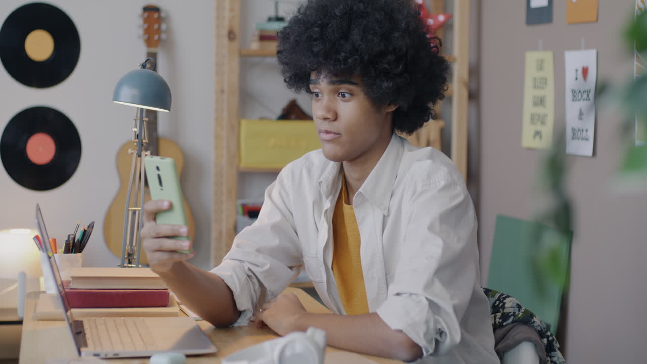 Teenager Using Smartphone in Bedroom