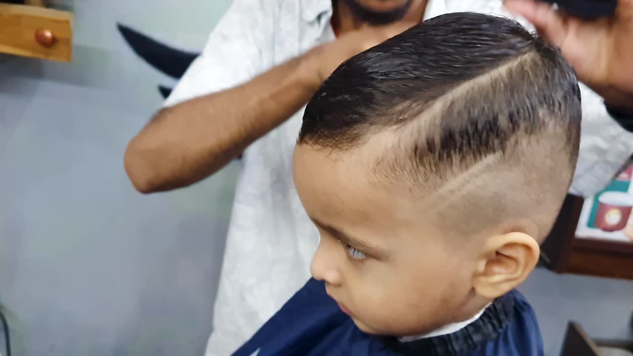 child hair cutting indoors at salon at indoor