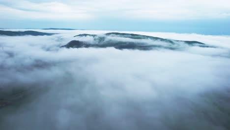 the foggy aerial view stock footage of banska bystrica, the soft, white fog blankets the hillsides, creating a tranquil and peaceful ambiance