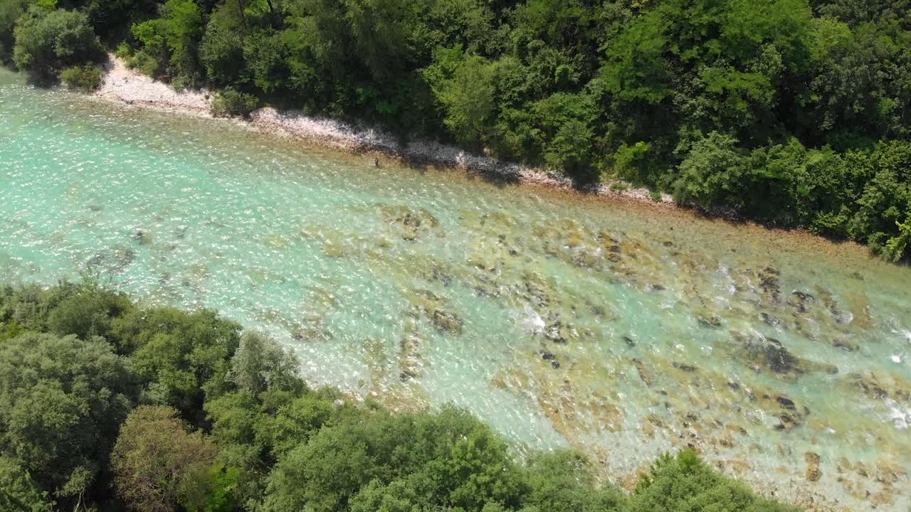 Top down circular drone shot of fisherman fishing in beautiful river in Slovenia