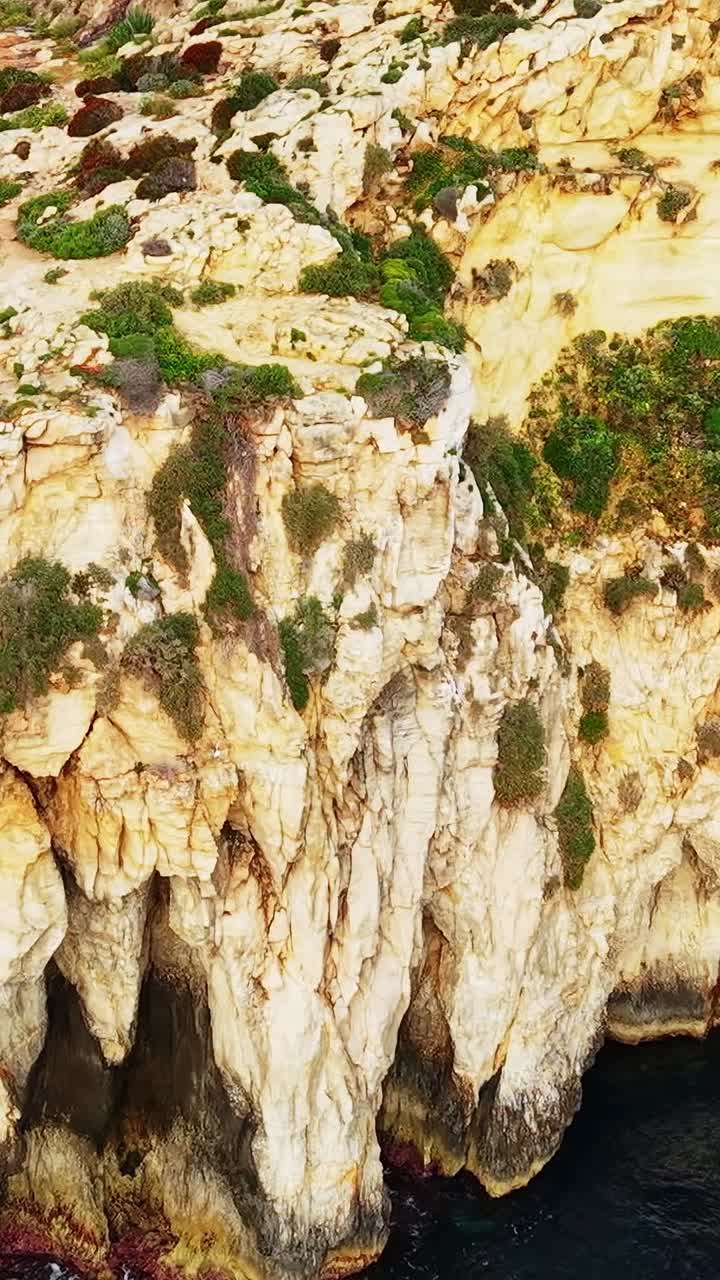 View of rocky cliffs and clear water in Malta during the day
