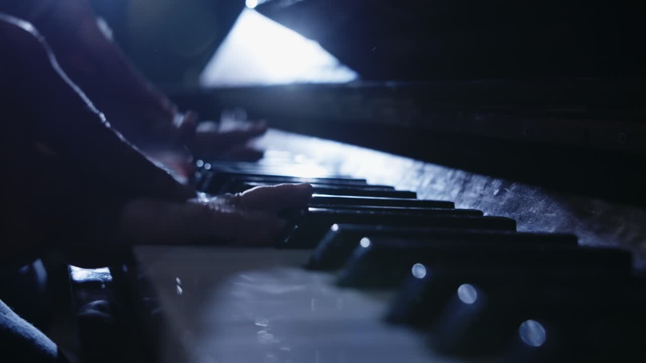 Close Up of Hands Playing Piano in Low Light