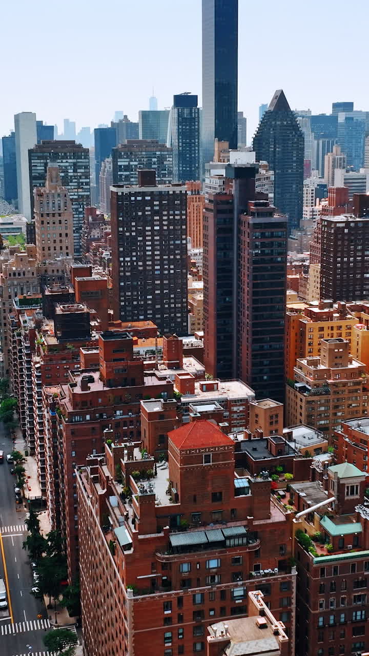 Part of New York above the beautiful Hudson River. Multistoried buildings at backdrop of skyscrapers. Top view. Vertical video