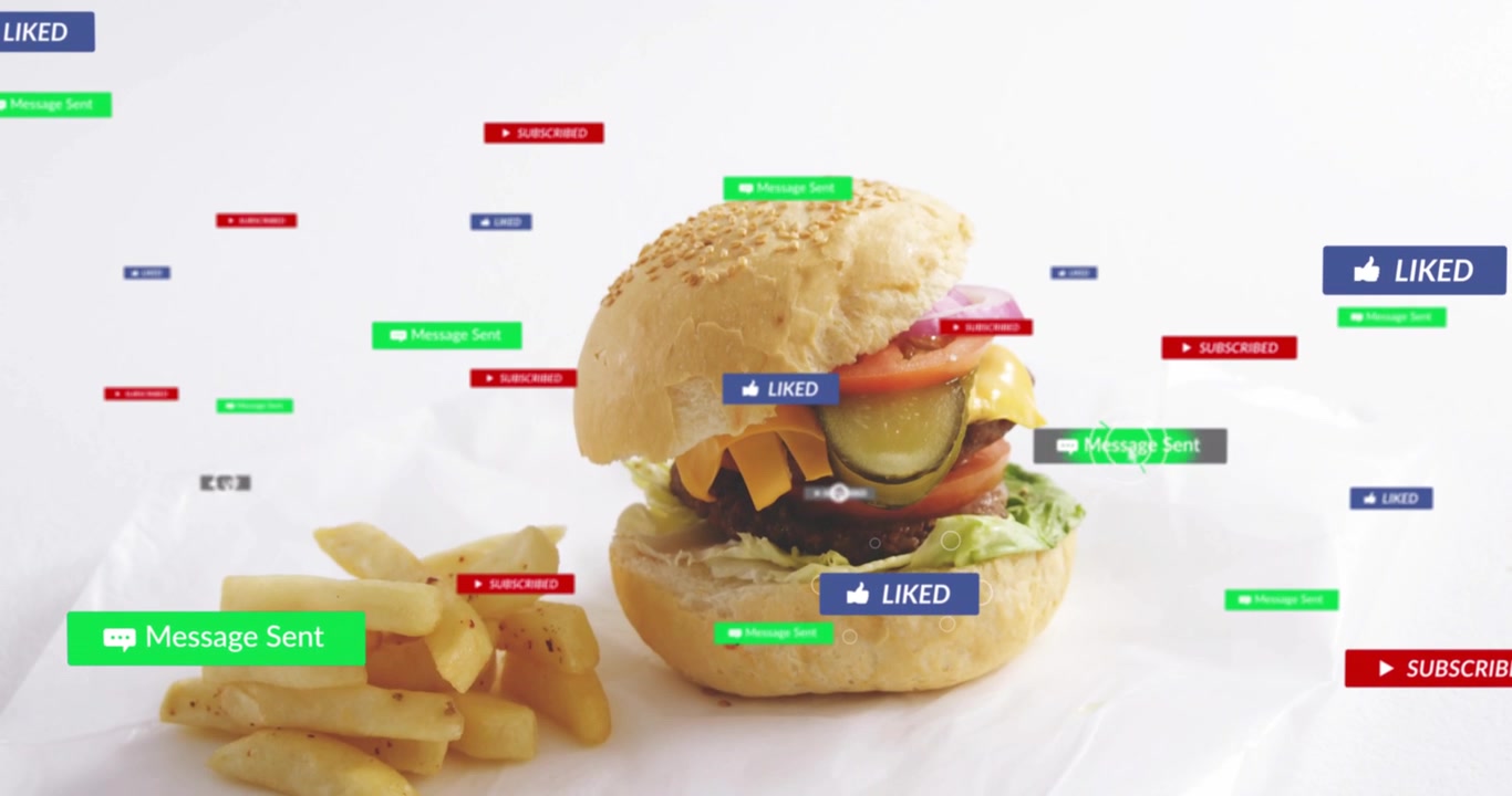 Vertical video: Drifting badges entering frame, circling burger and fries on sheet, showing likes
