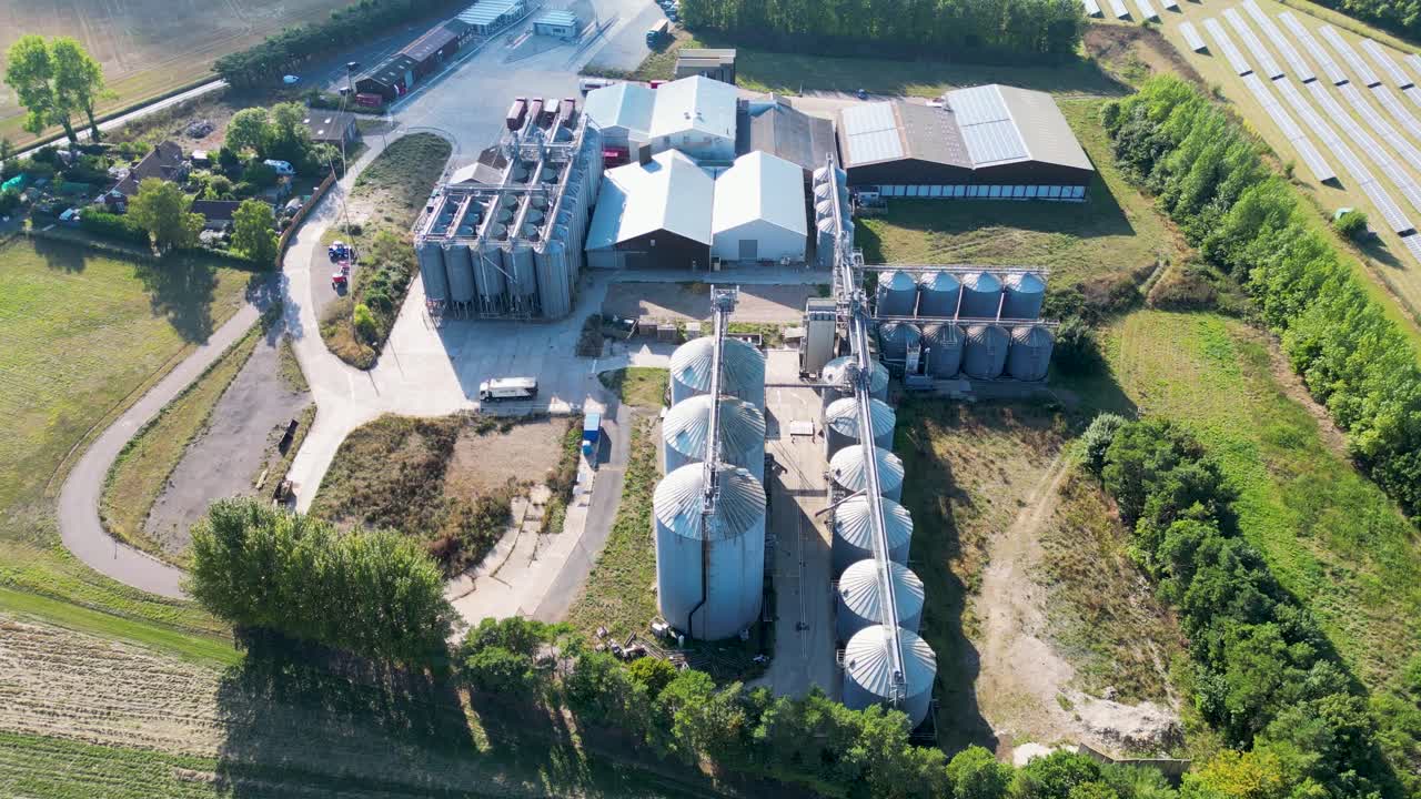 Dolly forward aerial shot of industrial sized silos