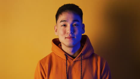 portrait of a man in an orange hoodie