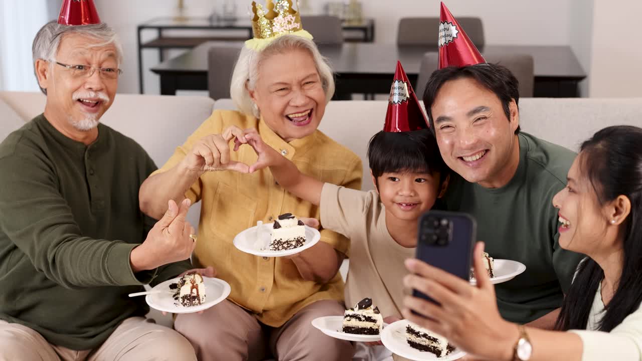 A joyful family gathering with cake, party hats, and selfies, capturing a moment of happiness and togetherness