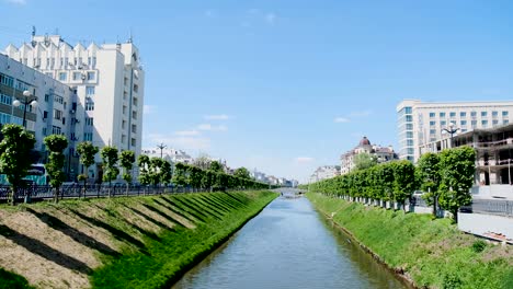 city canal scene with buildings and trees