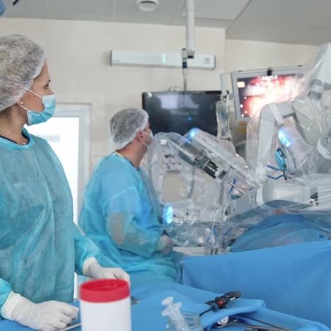 professional team of surgeons work in the surgery room. doctors standing near the patient and observe his condition on the monitor