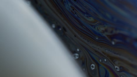 macro shot of bubble surface with rainbow colored hues on surface
