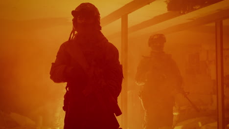 silhouette of soldiers in a firey environment
