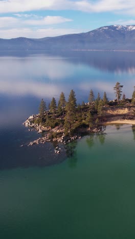 Vertical-Aerial-View,-Sand-Harbor-Park-and-Calm-Lake-Tahoe-Water-on-Sunny-Winter-Day,-Nevada-USA