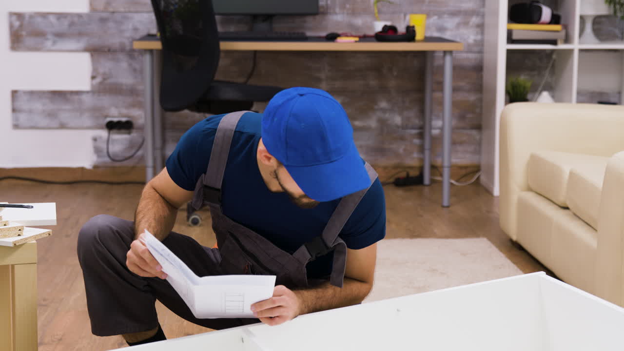 Man Assembling Furniture with Instruction Manual