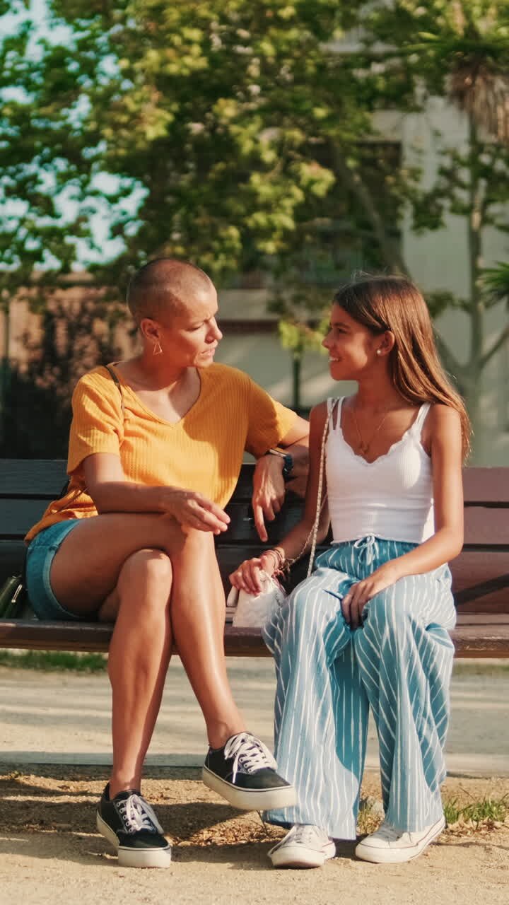 Mother and Daughter With Alopecia Bond in Park