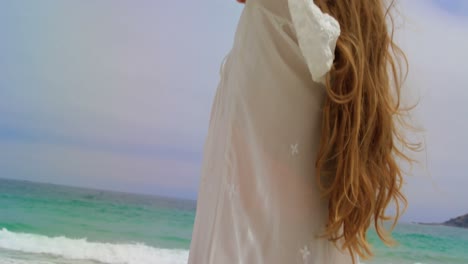 low angle view of happy caucasian woman standing on the beach 4k