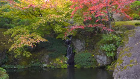 Stunning-scenery-of-vibrant-fall-colors-with-waterfall-and-lake