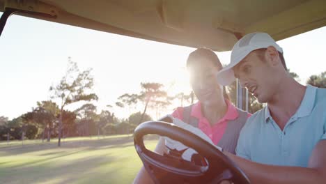 Golfspieler-Sitzen-Im-Golfbuggy-Und-Benutzen-Ihr-Mobiltelefon