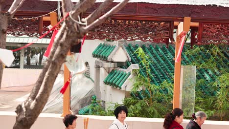 people walking past temple in hong kong