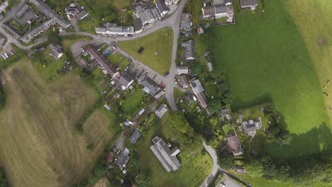aerial view of a rural village with houses, fields, and church