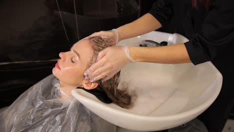 woman getting her hair washed in a salon