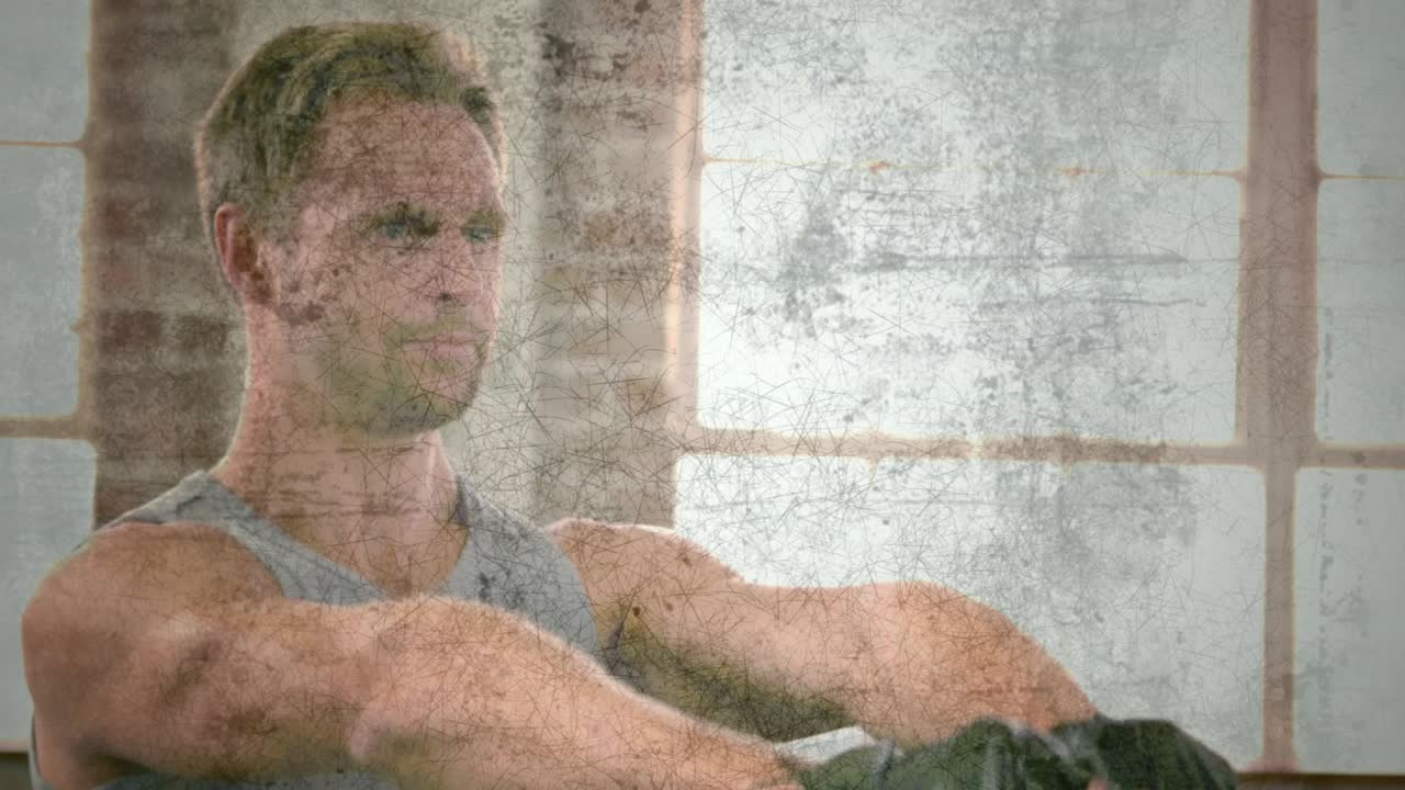 Man gripping kettlebell and raising it in fitness gym, training while grunge overlay shifting