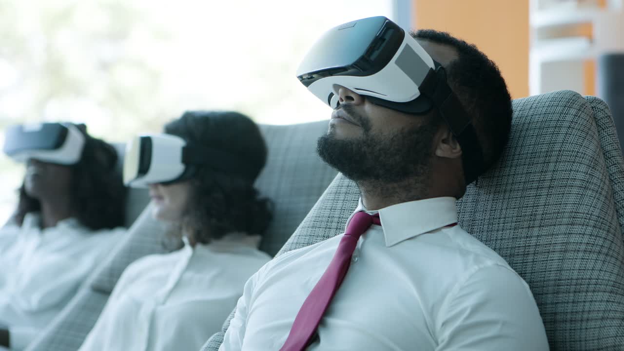 Business colleagues using virtual reality headsets