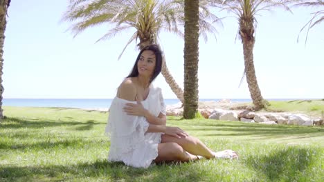 Single-woman-sitting-among-palm-trees