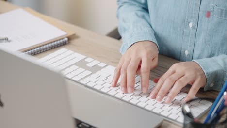 close up hand of a business woman typing keyboard desktop computer on desk office