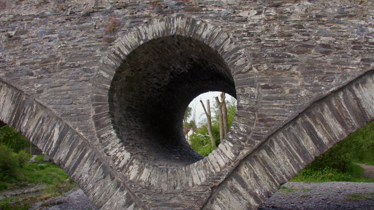 shot of the man made stone holes in the Cenarth bridge at Cenarth Falls on the river Teifi